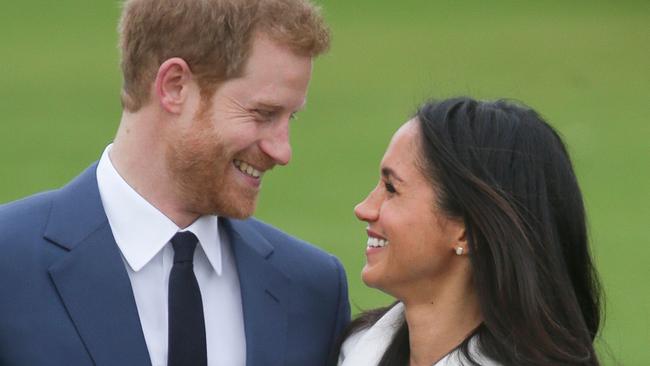 (FILES) In this file photo taken on November 27, 2017 Britain's Prince Harry and his fiancée US actress Meghan Markle pose for a photograph in the Sunken Garden at Kensington Palace in west London on November 27, 2017, following the announcement of their engagement. Prince Harry, who marries US former actress Meghan Markle on May 19, 2018 has been transformed in recent years from an angry young man into one of the British royal family's greatest assets. / AFP PHOTO / Daniel LEAL-OLIVAS