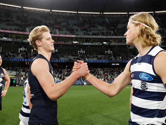 MELBOURNE, AUSTRALIA – JULY 16: Sam De Koning of the Cats and Tom De Koning of the Blues shake hands after the 2022 AFL Round 18 match between the Carlton Blues and the Geelong Cats at the Melbourne Cricket Ground on July 16, 2022 in Melbourne, Australia. (Photo by Dylan Burns/AFL Photos via Getty Images)