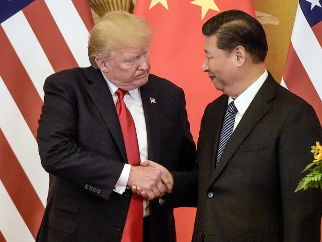 (FILES) In this file photo taken on November 9, 2017, US President Donald Trump (L) shakes hand with China's President Xi Jinping in Beijing. - Trump on November 1, 2018, said he'd just had "very good" talks with his Chinese counterpart Xi Jinping on the growing trade conflict between the two economic giants. "Just had a long and very good conversation with President Xi Jinping of China. We talked about many subjects, with a heavy emphasis on Trade," Trump tweeted. (Photo by Fred DUFOUR / AFP)