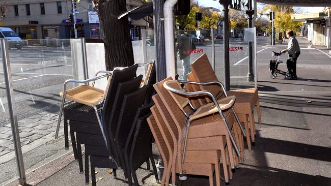 Cafe chairs are stacked up on the Lygon Street cafe and restaurant strip in Melbourne amid Victoria’s lockdown today. Picture: AFP