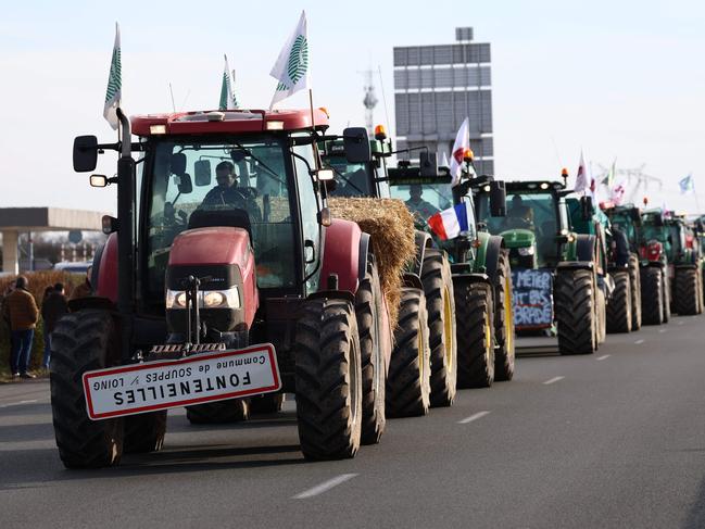 French farmers drive tractors to take part in road block protests on the A6 highway near Ormoy, south of Paris, on Monday. (Photo by EMMANUEL DUNAND / AFP)