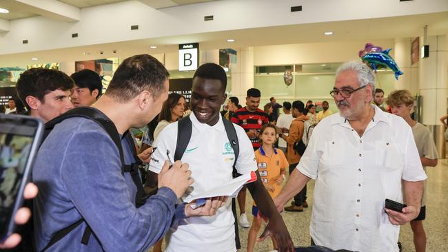 The Socceroos were given a hero’s welcome in their Australian homecoming, as fans ask Garang Kuol for an autograph and photos. Picture: Getty Images.