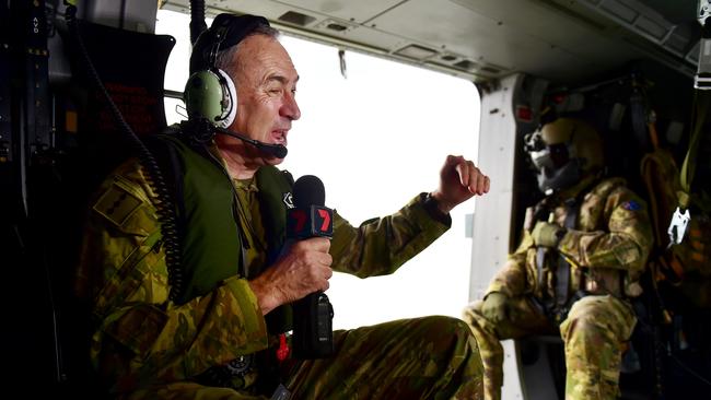 Mark Beretta on board an MRH-90 during a flypass over the Townsville 400 Supercars event. Picture: Alix Sweeney