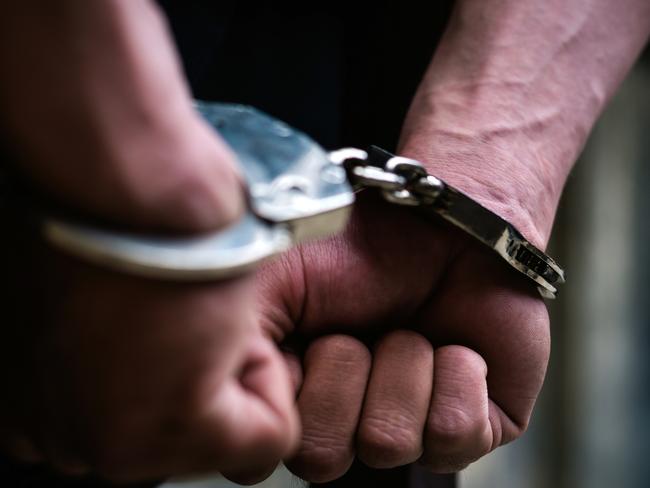 Man on the chair in Handcuffs. Rear view and Closeup ,Men criminal in handcuffs arrested for crimes. With hands in back,boy  prison shackle in the jail violence concept. Picture: Istock