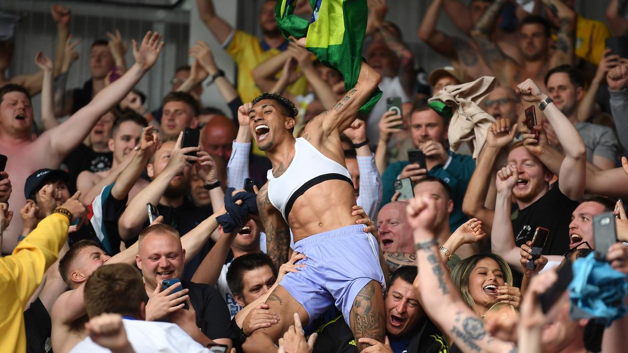 Raphinha celebrates survival with the Leeds fans in the away end. (Photo by Alex Davidson/Getty Images)