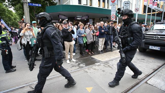 Heavily armed Special Operations Group police patrol Bourke St. Picture: David Caird