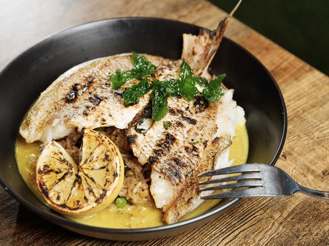 Charcoal whole baby Snapper with green curry, fried rice and burnt lemon main course at Crackerjack restaurant at Cooroy on the Sunshine Coast. Picture Lachie Millard
