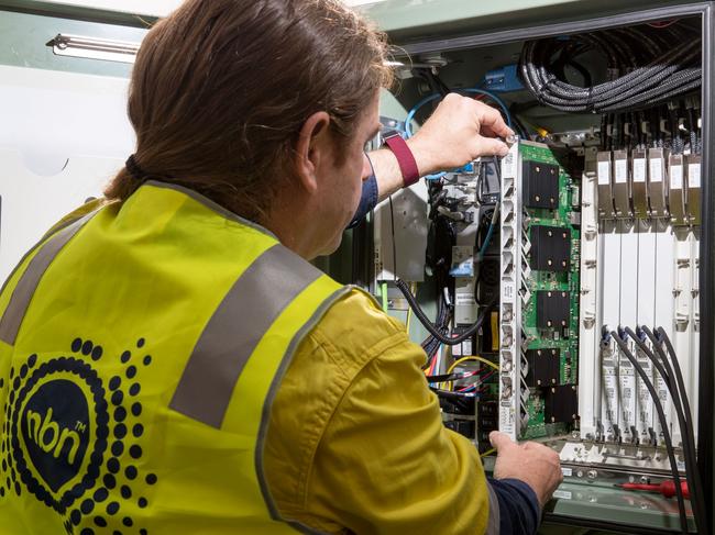 An NBN Co. technician handles hardware in a fiber distribution cabinet during the installation of fiber-to-the-building connections in Sydney, Australia, on Tuesday, Oct. 3, 2017. NBN says it's aiming to increase annual revenue more than five-fold to A$5.4 billion and be cash flow positive in 2021. Photographer: Cole Bennetts/Bloomberg