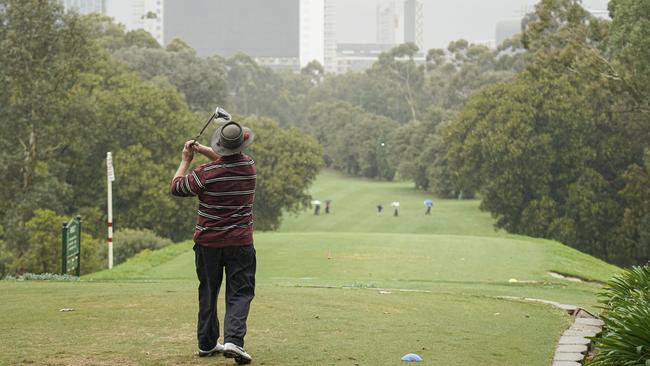 Golfers tee off in wet conditions at North Adelaide Golf Links. Picture: Mike Burton