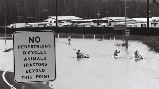 February 1992 flood. Paddlers out on the Sunshine Motorway entry/exit at Bradman Ave. Maroochydore.