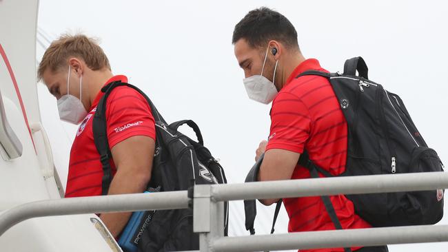 Dragons players Jack de Belin, left, and Corey Norman board a plane for Queensland. Picture: Toby Zerna