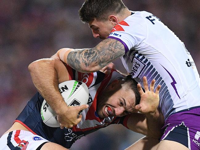 James Tedesco of the Roosters is tackled by Curtis Scott of the Storm during the NRL Preliminary Final match between the Sydney Roosters and Melbourne Storm at the SCG in Sydney, Saturday, September 28, 2019. (AAP Image/Dan Himbrechts) NO ARCHIVING, EDITORIAL USE ONLY