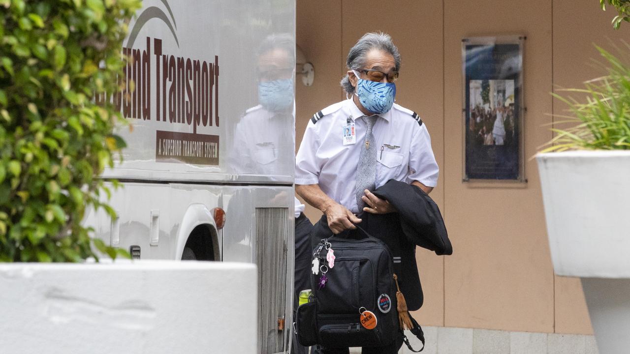 A United Airlines crew member leaving the Novotel Hotel in Darling Harbour in December after a cleaner tested positive. Picture: Jenny Evans/Getty Images