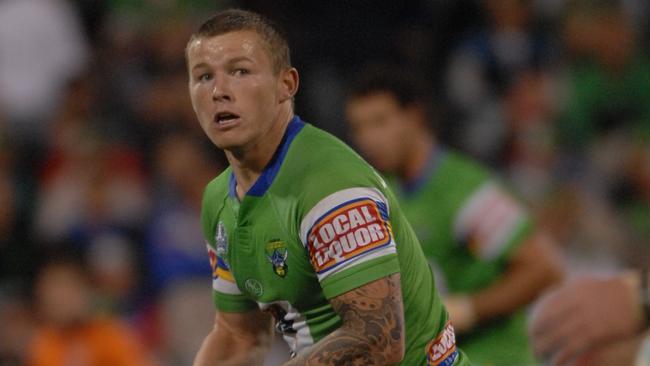 Todd Carney looks to get his pass away.