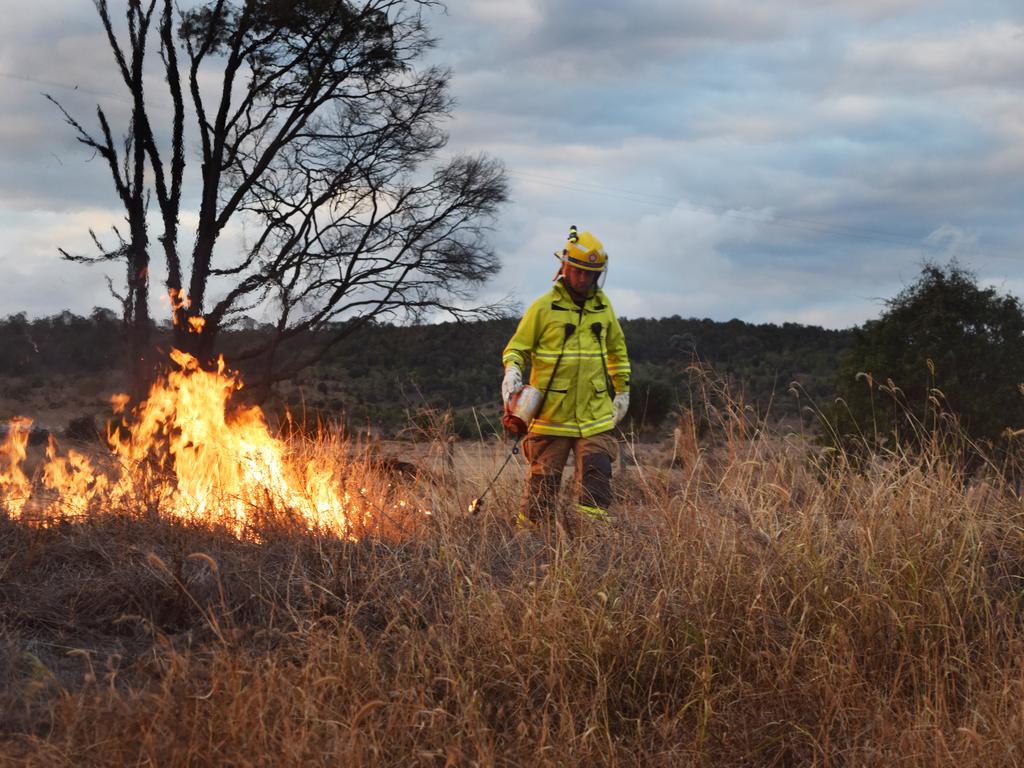 A firefighter initiates a backburning operation.