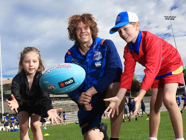 Landsdowne Crescent Primary School students Connie Walker and Maverick Bradley at the football super clinic with North Melbourne AFL star, Ben Brown. Picture: LUKE BOWDEN