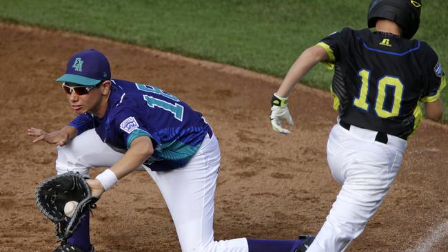 Italy’s first baseman Tommaso Adorni (18) gets the out at first base against Australia's Brent Iredale (10) to end the first inning. Picture: AP