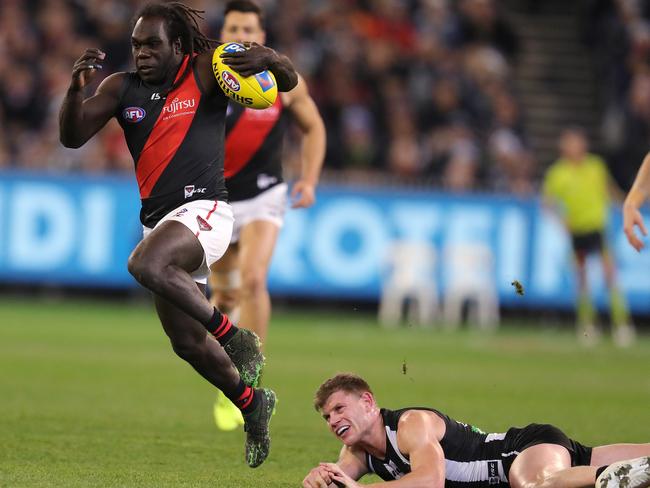 Anthony McDonald-Tipungwuti bursts clear after breaking the tackle of Collingwood’s Taylor Adams. Picture: Michael Klein