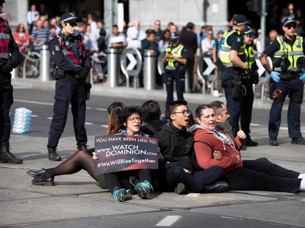 The last remaining protesters were dispersed from the middle of Melbourne’s busiest intersection. Picture: Ellen Smith/AAP