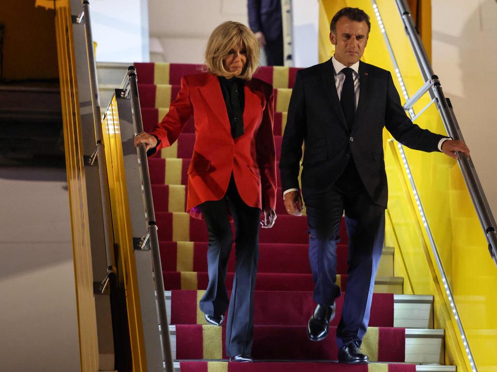 France’s President Emmanuel Macron and his wife Brigitte Macron just moments after the shocking incident. Picture: AFP