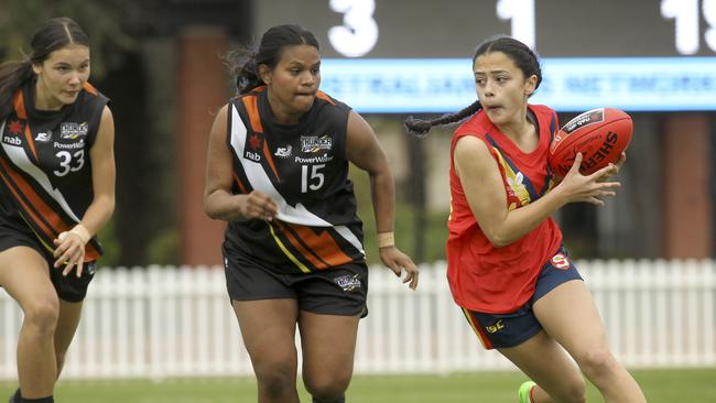 Laitiah Huynh with the ball in action for SA is pursued by NT’s Tulaha Jeffrey and Makaylah Siddons during the 2019 AFLW under-18 championships. Picture: Dean Martin