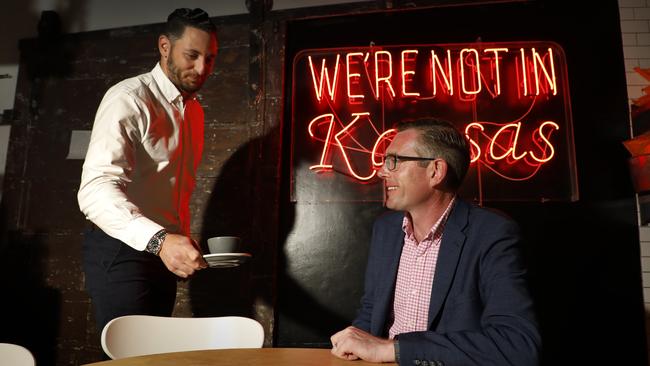 Ben Sweeten from Kansas City Shuffle cafe in The Rocks, brings NSW Treasurer, Dominic Perrottet a morning coffee. Picture: Chris Pavlich