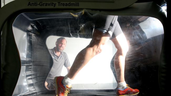 Movement Lab’s Glenn Phipps takes Coolangatta Gold’s Over 50s winner Paul Lemmon through his paces on the NASA inspired Anti Gravity Treadmill at Terrigal. (AAP Photo/Sue Graham)