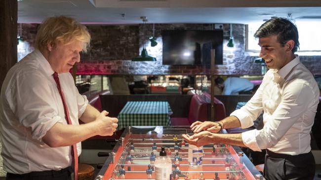 British Prime Minister Boris Johnson and Chancellor Rishi Sunak use hand sanitiser during a visit to Pizza Pilgrims in West India Quay, London Docklands in 2020.