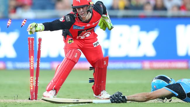 Renegades wicketkeeper Sam Harper whips off the bail to run out Strikers batsman Matthew Short. Picture: Getty Images