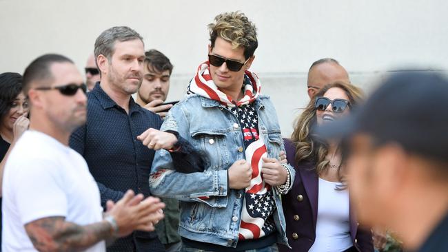 Conservative commentator Milo Yiannopoulos is escorted onto the University of California, Berkeley campus on September 24. Picture: AFP/Josh Edelson