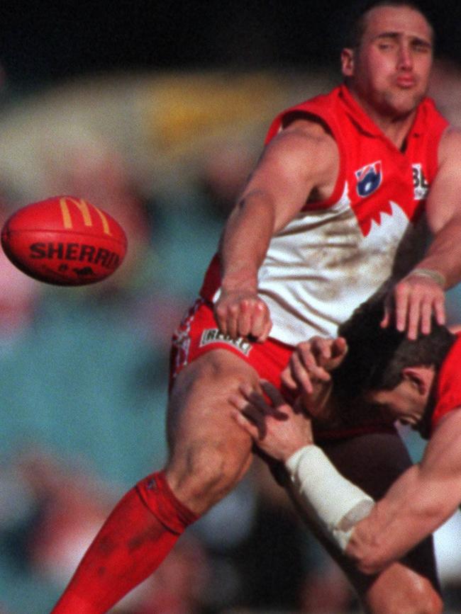 Shaun Smith is ironed out by Tony Lockett in 1997.