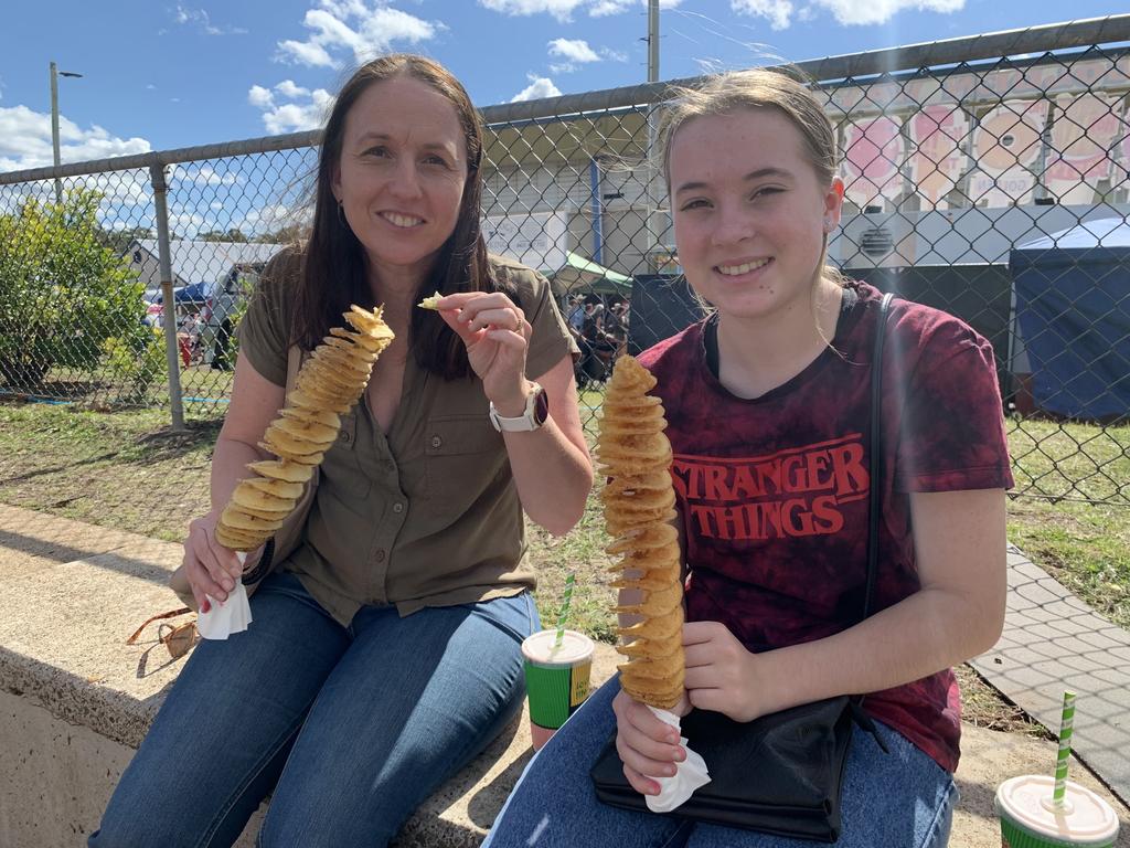 Tracy and Amber Glock from Howard enjoy a potato swirl at the Fraser Coast Ag Show for 2021. Photo: Stuart Fast