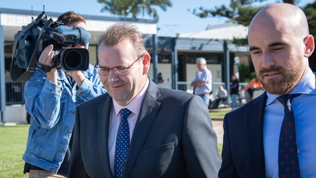 Former Tasmanian Liberal candidate Adam Brooks arrives at Redcliffe Magistrates court with his lawyer to face charges by Queensland police for being in possession of a handgun, unauthorised explosives and false driver's licences. PICTURE: Brad Fleet