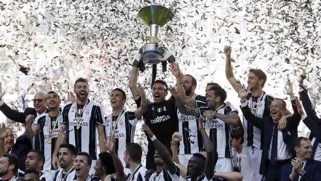 Juventus goalkeeper Gianluigi Buffon lifts the trophy.
