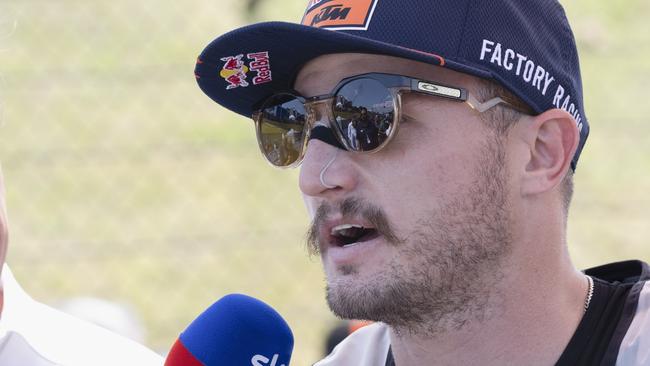 HOHENSTEIN-ERNSTTHAL, GERMANY - JUNE 18:  Jack Miller of Australia and Bull KTM Factory Racing speaks with journalists and prepares to start on the grid during the MotoGP race during the MotoGP of Germany - Race at Sachsenring Circuit on June 18, 2023 in Hohenstein-Ernstthal, Germany. (Photo by Mirco Lazzari gp/Getty Images)