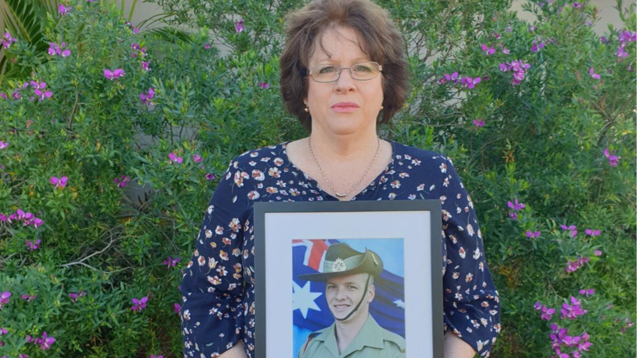 Colleen Pillen holding a picture of her son Michael John Powers