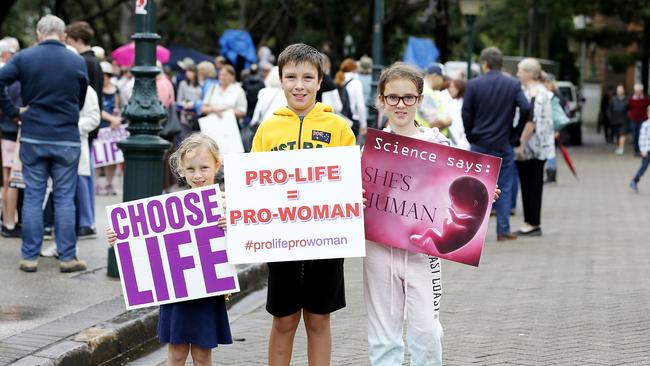 Amelia, 5, Joshua, 10 and Alyssa Balantyne, 8 posing at the Cherish Life, Rally for Life rally outside Parliament House in October 2018.