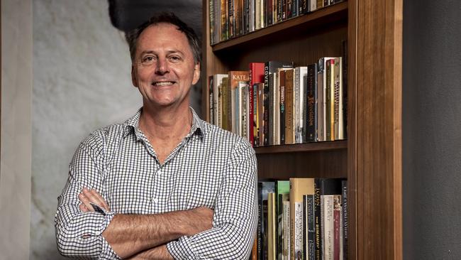 Hills Shire Times Restaurant manager Richard Kemp with the book case that conceals the entrance to a private function room. Picture: Monique Harmer