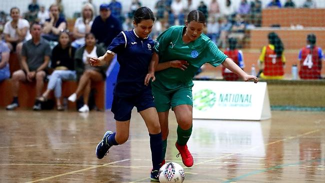 Allegra Angel (left) battles for possession with an opponent at the futsal national championships.