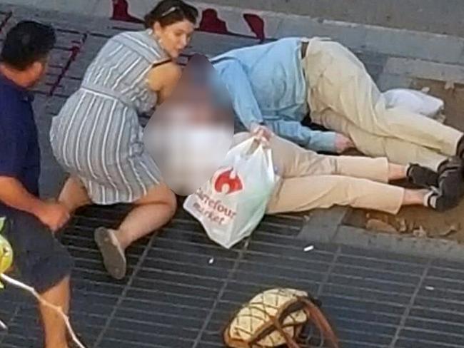 People attend to injured persons at the scene after a van crashed into pedestrians near the Las Ramblas avenue in central Barcelona, Spain August 17, 2017. Picture: Giselle Loots/Reuters