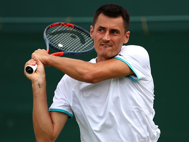 LONDON, ENGLAND - JULY 02: Bernard Tomic of Australia plays a backhand in his Men's Singles first round match against Jo-Wilfred Tsonga of France during Day two of The Championships - Wimbledon 2019 at All England Lawn Tennis and Croquet Club on July 02, 2019 in London, England. (Photo by Clive Brunskill/Getty Images)