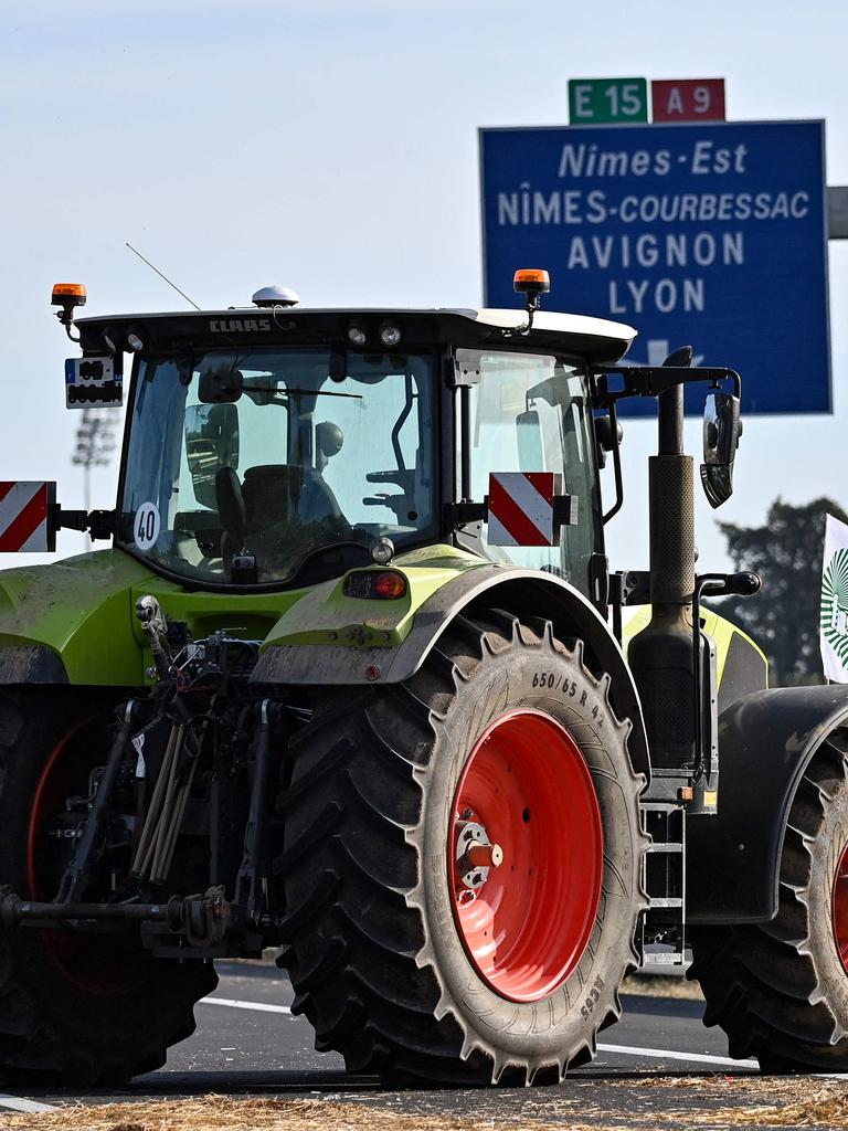 French farmers man a road block with their tractors as they near Nimes, southern France. (Photo by Sylvain THOMAS / AFP)