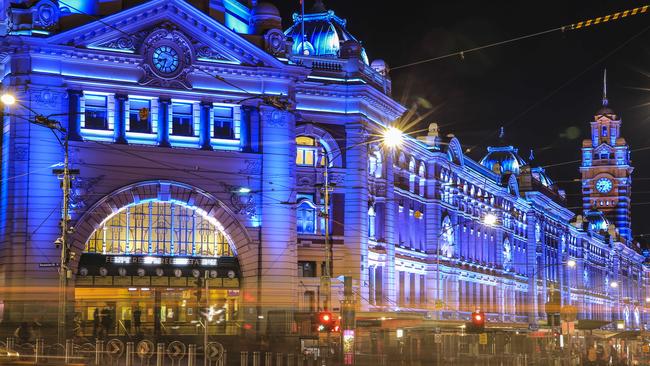 Flinders St Station has been lit up in blue to support FightMND. Picture: Wayne Taylor