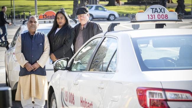 Taxi licence owners Devi Sharma and Tony Bell with community advocate and barrister Mala Crew in Hobart. Picture: Chris Kidd