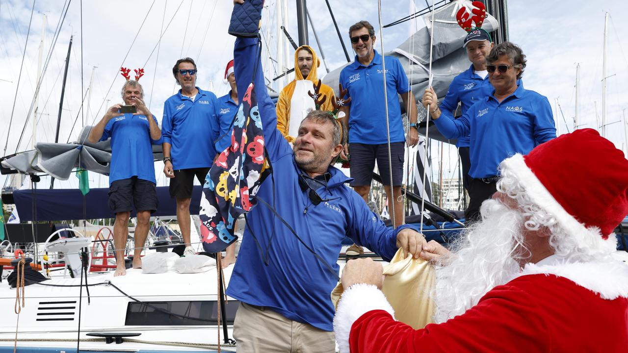 DECEMBER 25, 2023 Pictured at the Cruising Yacht Club of Australia at Darling Point in Sydney is skipper of the yacht Charles Devanneaux and his European crew getting gifts from Santa before they head off on the 2023 Sydney to Hobart yacht race on Boxing Day. Picture: Richard Dobson