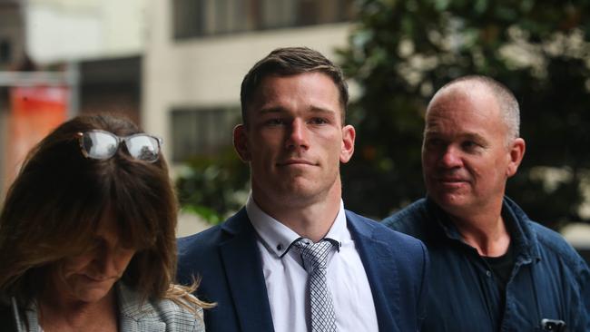 NRL player for the Canberra Raiders Tom Starling (wearing the blue suit and silver tie) is seen leaving the Downing Centre Court in Sydney with his family during his hearing. Picture: Gaye Gerard