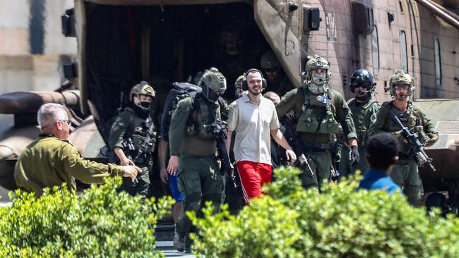 Israeli hostage Andrei Kozlov, 27, disembarks with soldiers from an air force CH-53 Sea Stallion military helicopter in Israel. Picture: AFP.