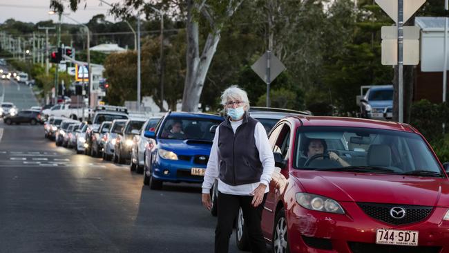 A motorist tries to reason with other drivers to move as queues of cars line up for Covid-19 testing at Caloundra on Wednesday afternoon. Picture: Lachie Millard