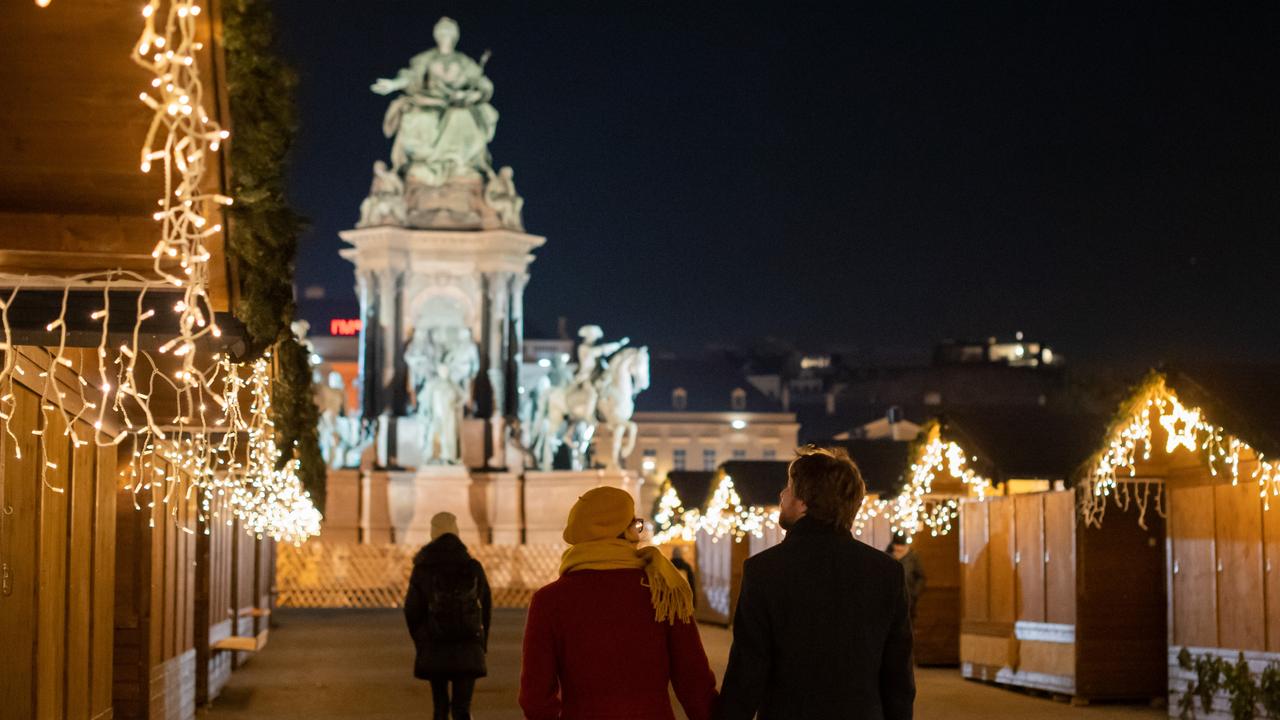 People walk past closed Christmas market stalls on Maria-Theresia square on the third day of a nationwide lockdown in Vienna, Austria. Picture: Thomas Kronsteiner/Getty Images