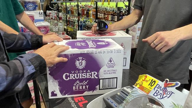 Schoolies buying cartons of cruisers. Picture: Georgina Noack